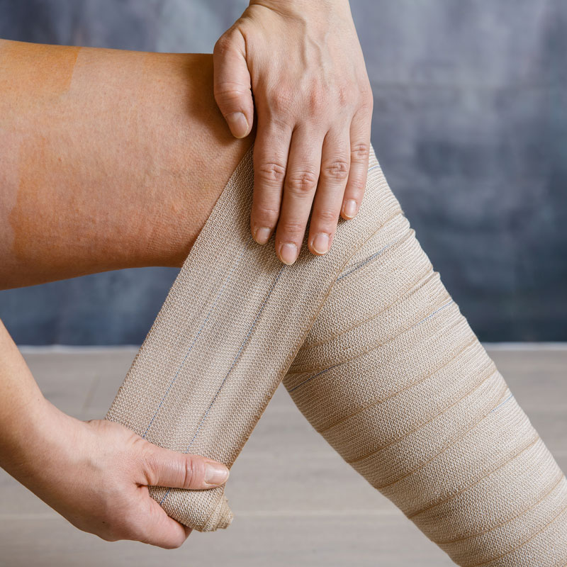 lady wrapping leg with bandage