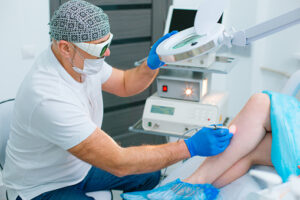 The doctor giving laser treatment for varicose vein patient at Phoenix, AZ