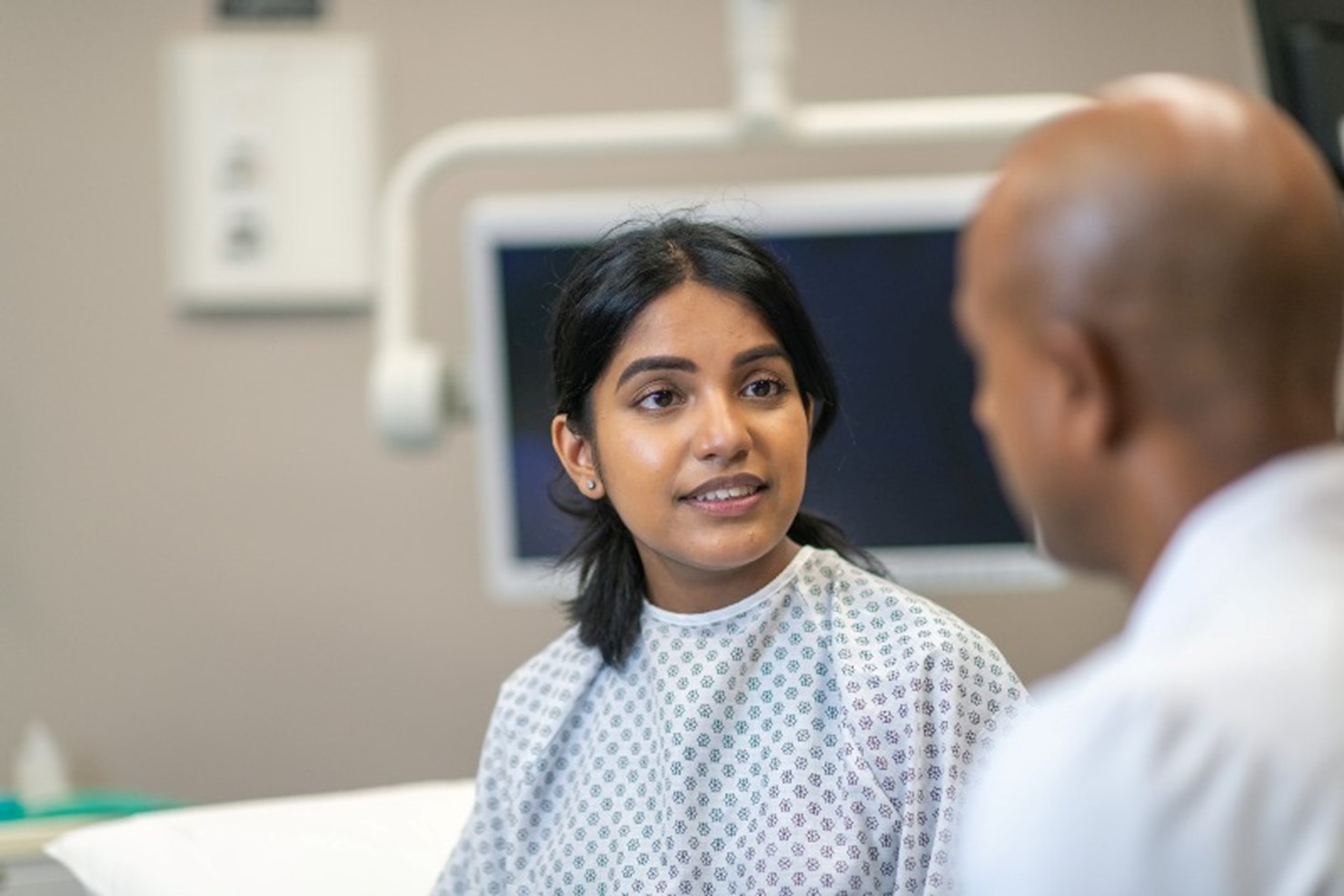 A woman talking to a doctor after having surgery by Arizona Vein & Laser Institute