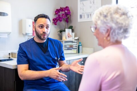 Vascular specialist consulting with patient about leg pain and vein health in Phoenix, AZ, & surrounding areas